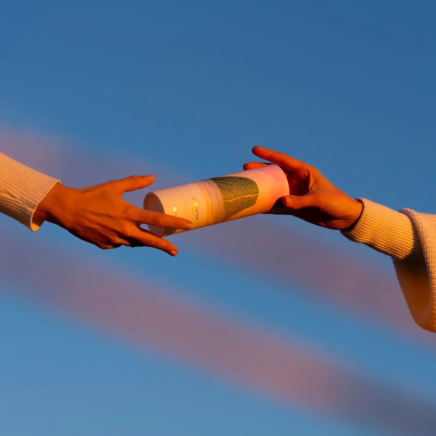 Two hands passing a baton between them.