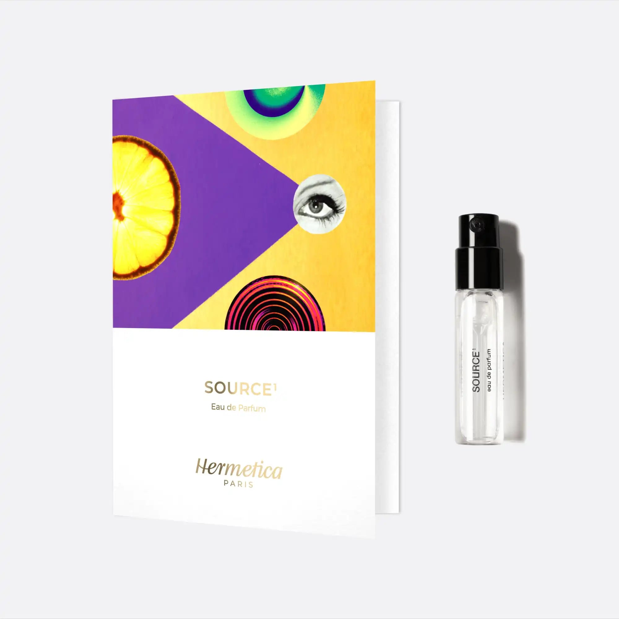 Colorful product packaging with abstract circular designs alongside a clear glass perfume vial.
