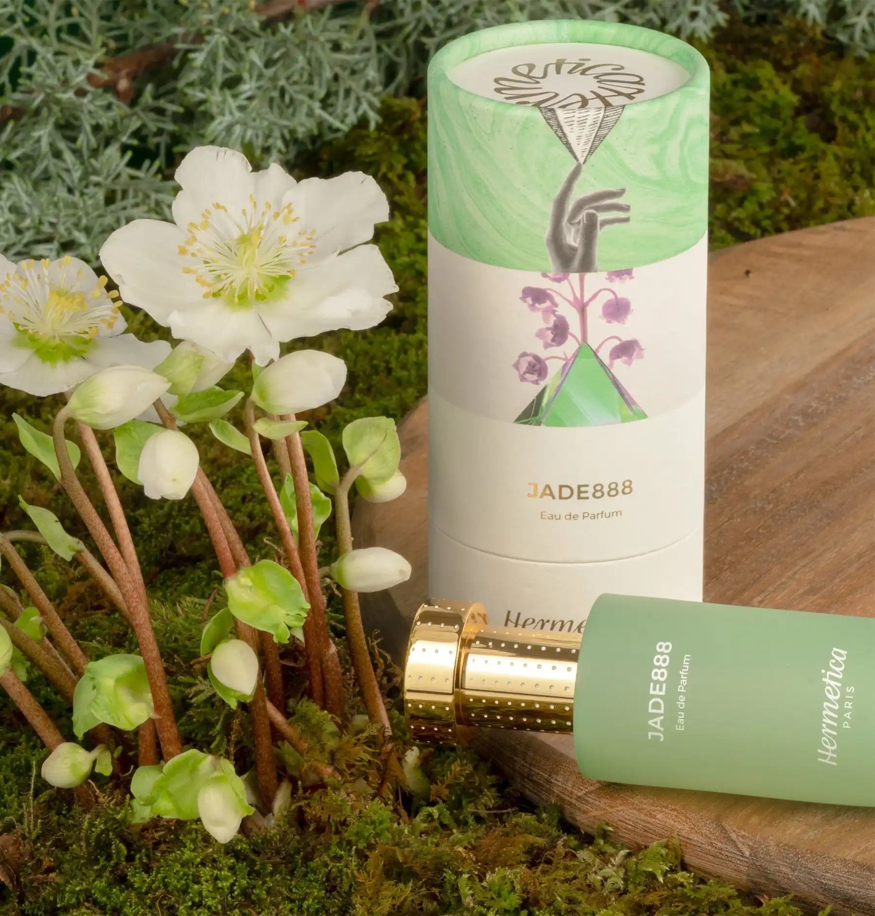 Mint green and white cylindrical product packaging with floral design elements.